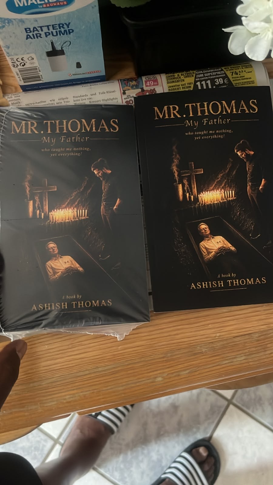 Yaya holding physical copy of Mr. Thomas: My Father